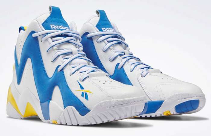 View of white, blue, and gold Reebok shoes.